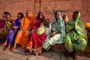 9891456-varanasi-india--july-22-2009-group-of-indian-women-in-colorful-saris-sit-and-watch-the-solar-eclipse