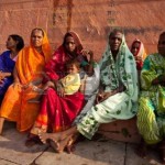9891456-varanasi-india–july-22-2009-group-of-indian-women-in-colorful-saris-sit-and-watch-the-solar-eclipse
